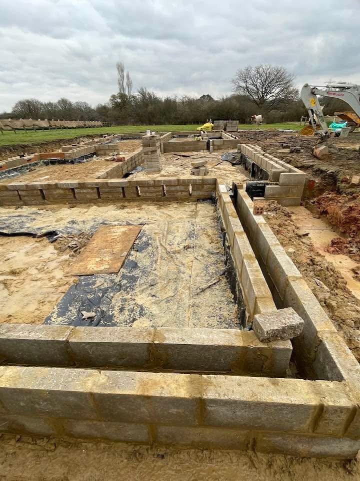 Concrete strip foundations with drainage pipework